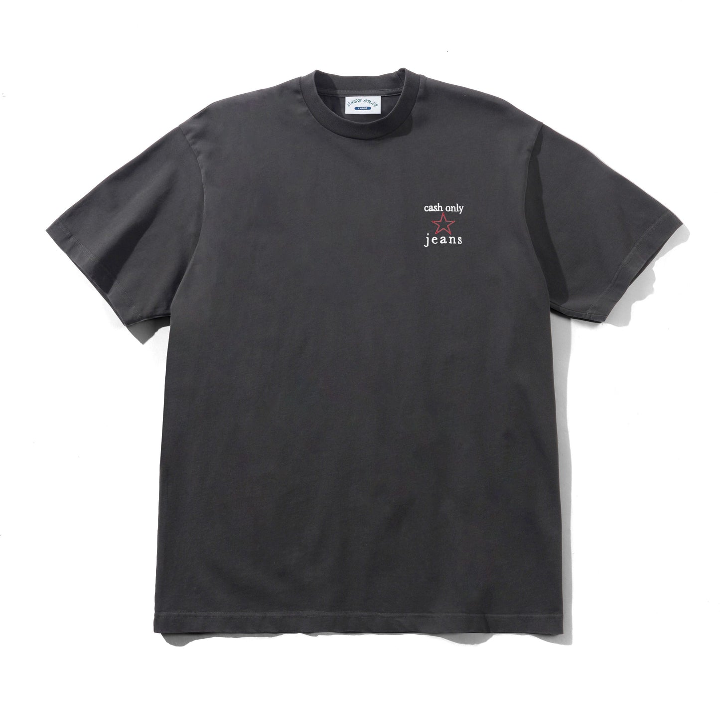 A dark charcoal gray short-sleeve t-shirt with a small white graphic on the left chest reading 'cash only' and 'jeans'. The shirt is laid flat against a white background with a soft shadow.