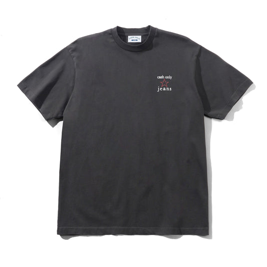 A dark charcoal gray short-sleeve t-shirt with a small white graphic on the left chest reading 'cash only' and 'jeans'. The shirt is laid flat against a white background with a soft shadow.