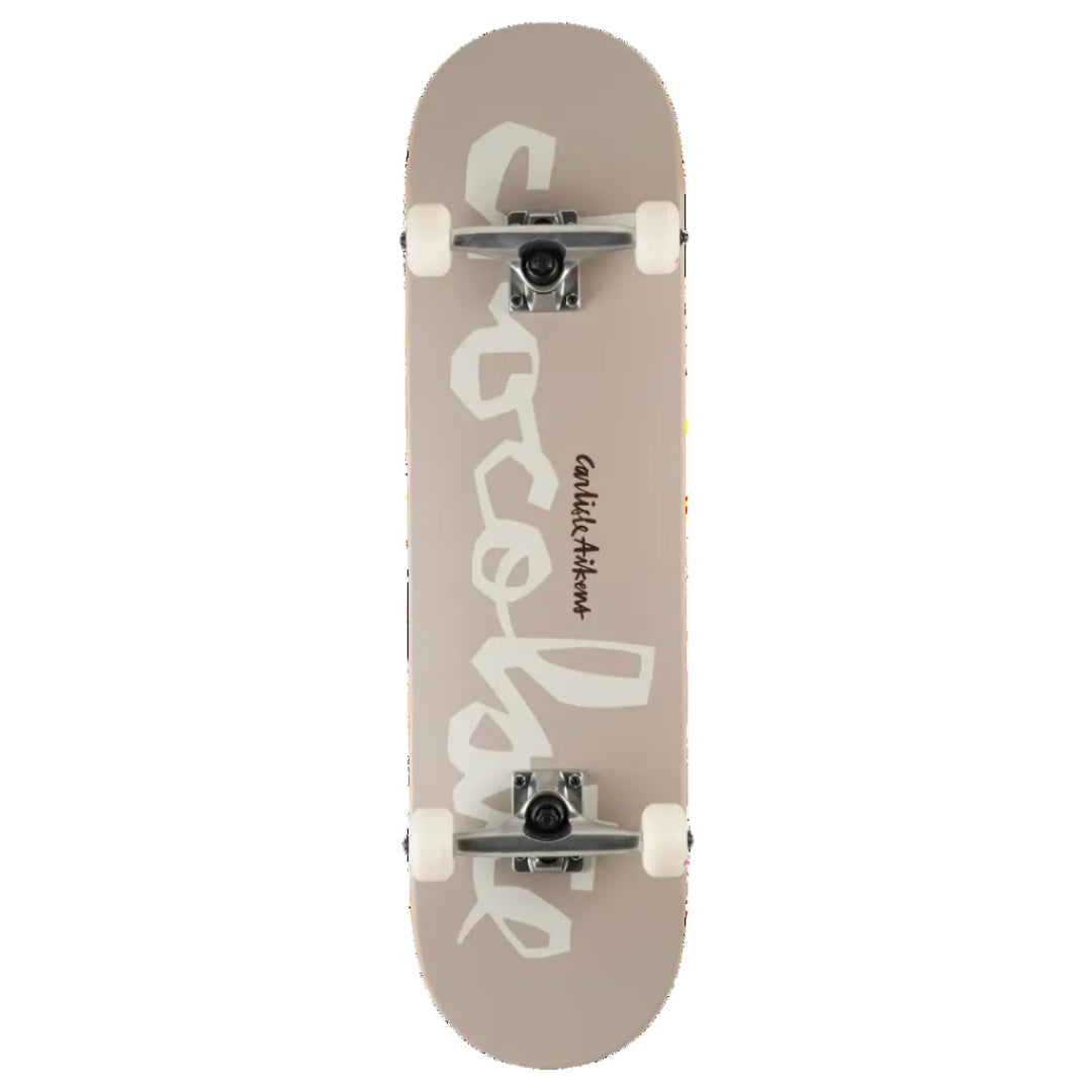 A skateboard shown from the underside, featuring a dusty taupe-beige deck with a large white graphic of the word 'chocolate'. The skateboard is equipped with white wheels and silver trucks, photographed against a solid white background.