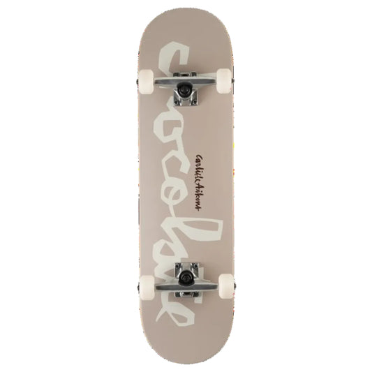 A skateboard shown from the underside, featuring a dusty taupe-beige deck with a large white graphic of the word 'chocolate'. The skateboard is equipped with white wheels and silver trucks, photographed against a solid white background.