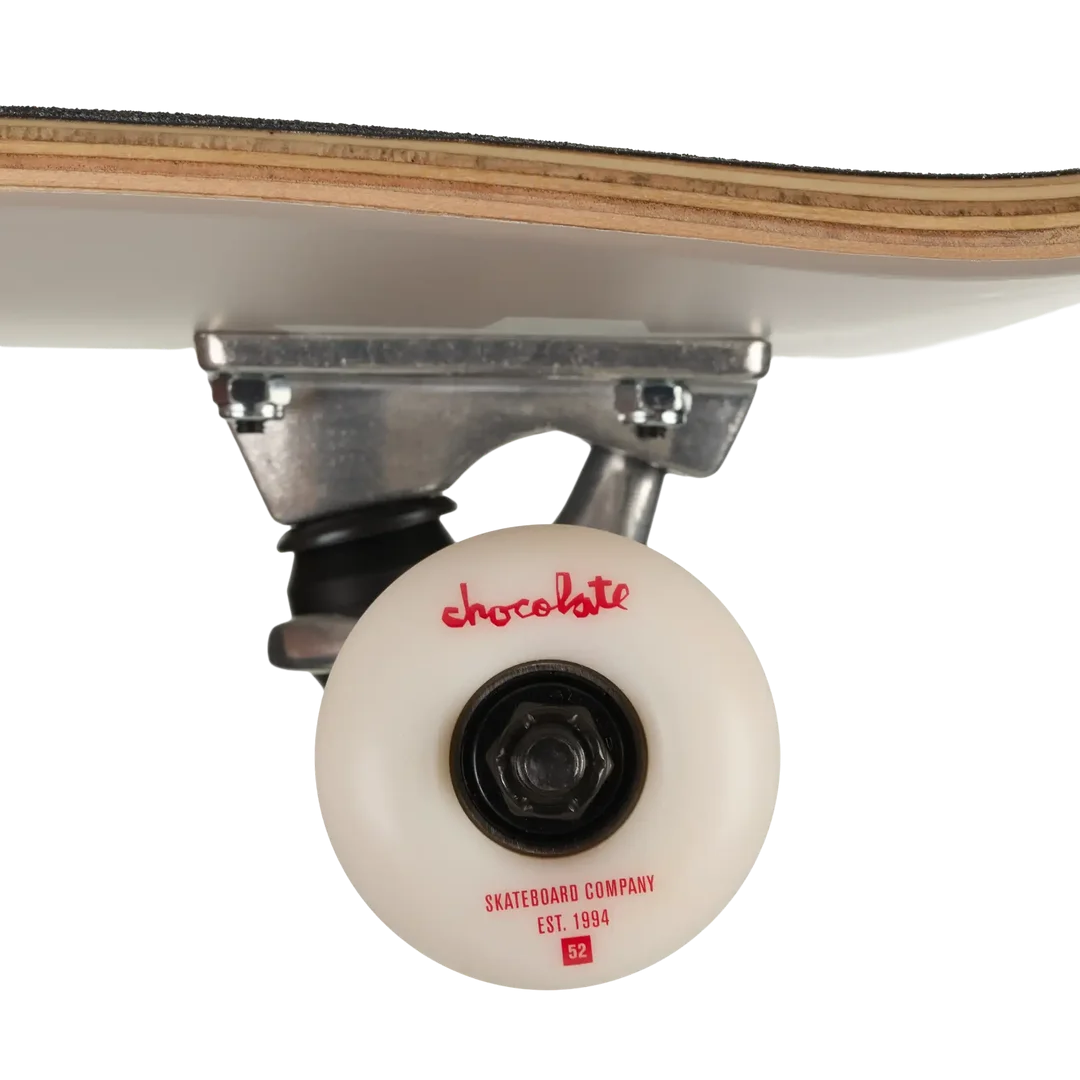Close-up of a skateboard wheel and truck assembly on a white background, showing a white wheel with red 'chocolate' branding and a light wood deck edge above.
