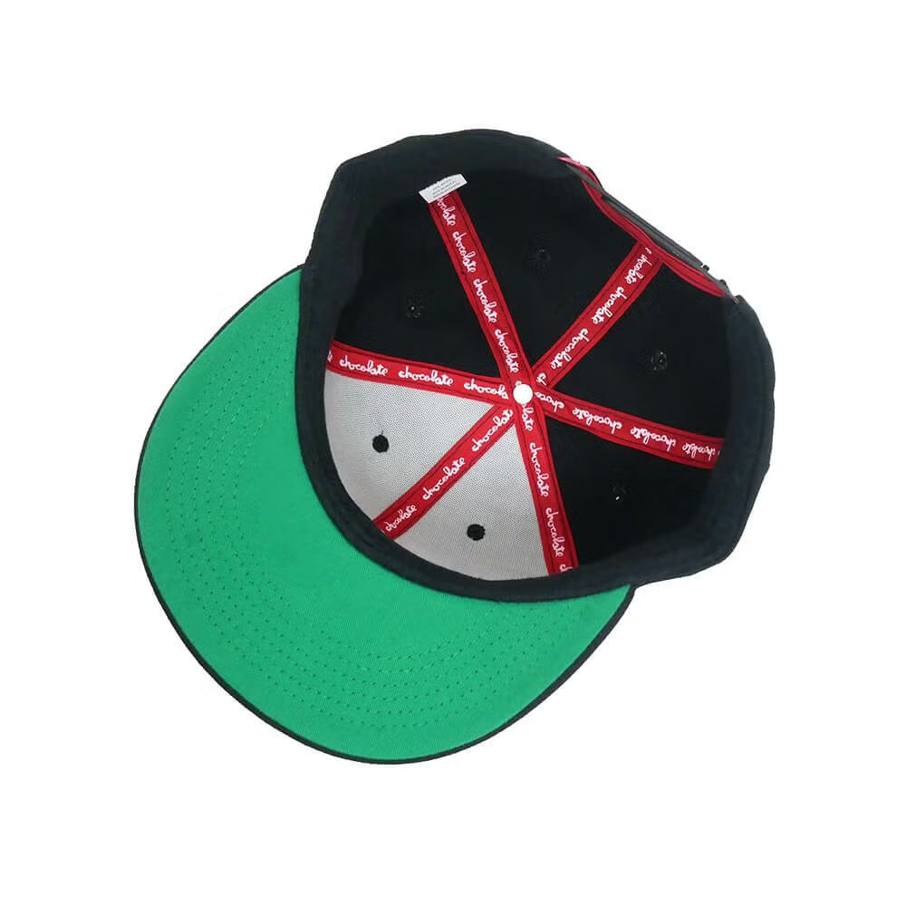 Black and green cap with red and white pattern on a white background
