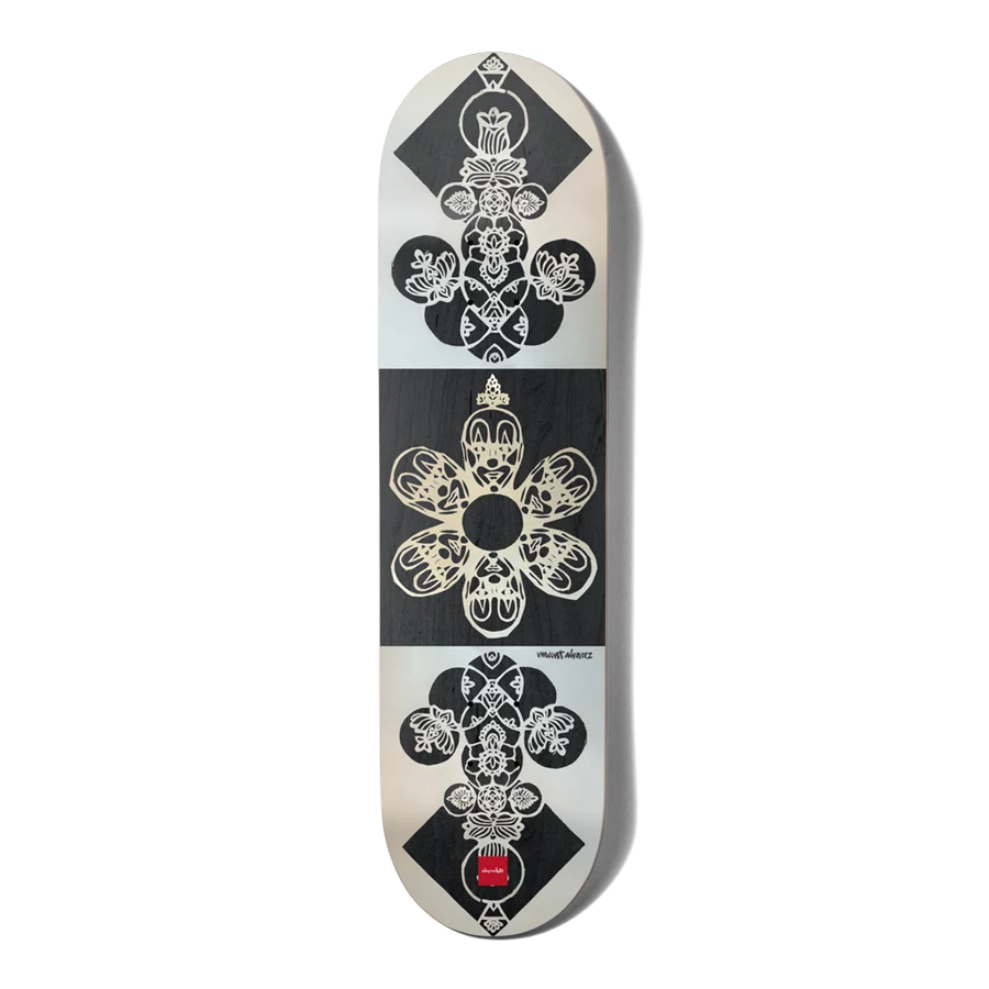 A skateboard deck featuring a symmetrical black and white graphic design inspired by a playing card suit, with a small red logo near the bottom.