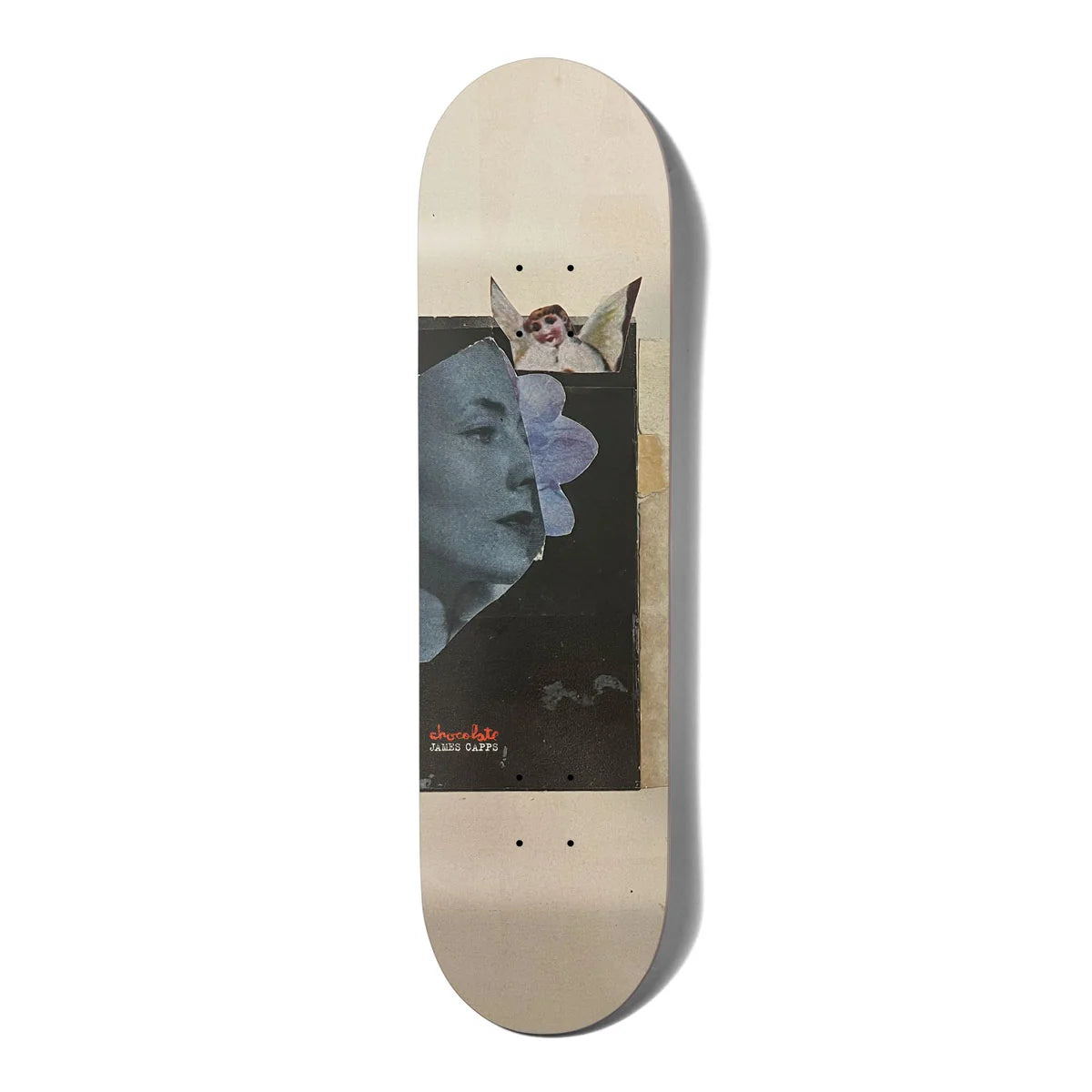 A skateboard deck with a light beige natural wood base, featuring a large graphic print of a split face portrait in black, blue-gray, and lavender, with a small angel figure at the top and red text near the bottom.