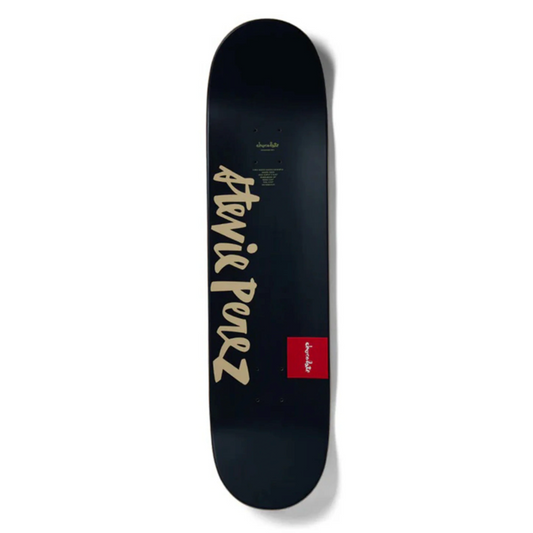 Black skateboard deck with gold text and a red logo on a white background