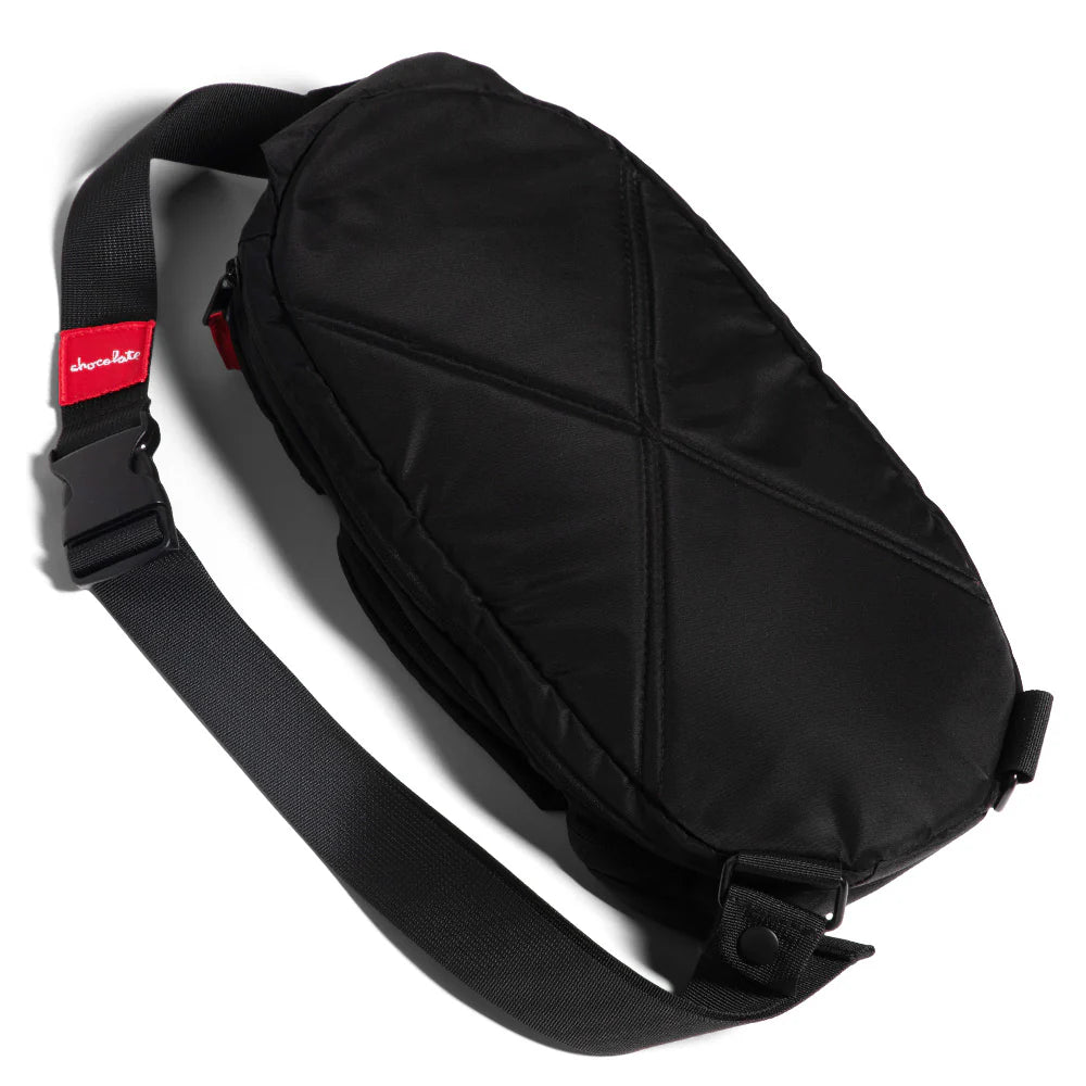 Black waist bag with a red label on a white background
