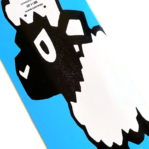 Close-up of a skateboard deck with a black and white graphic design on a blue background