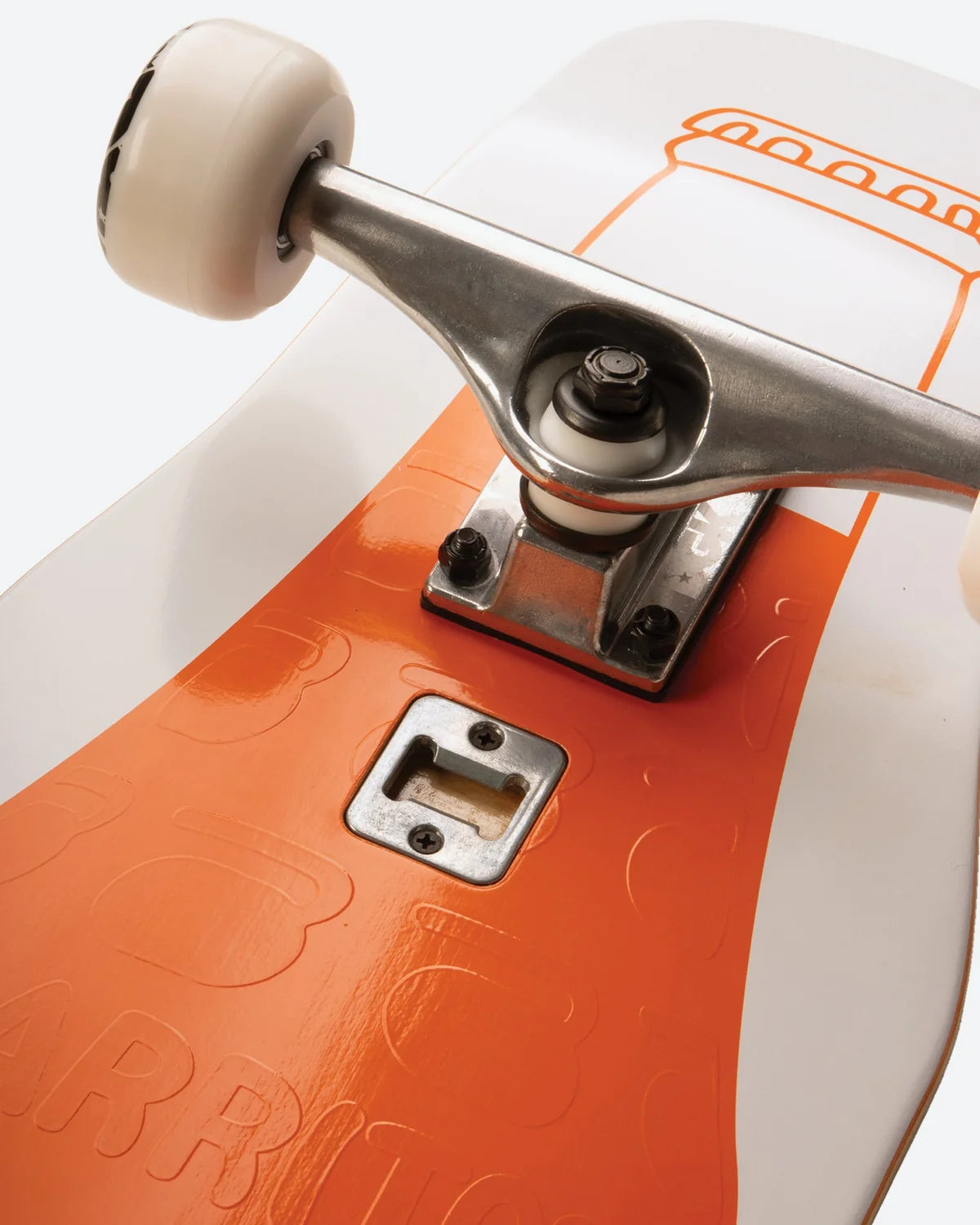 Close-up of a skateboard deck showing an orange and white graphic design, a silver metal truck, and a cream-colored wheel.