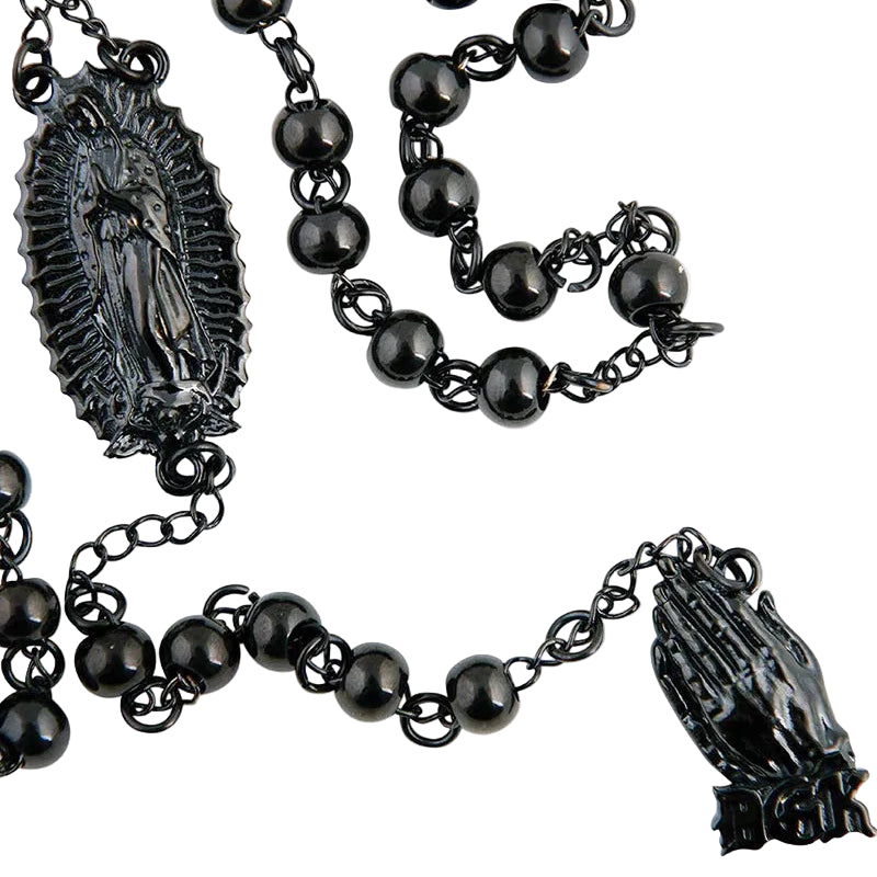Black rosary with black beads and religious symbols on a white background