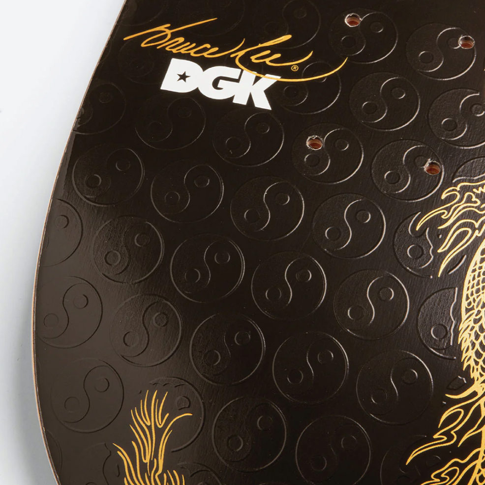 Close-up of a DGK skateboard with intricate designs and branding.