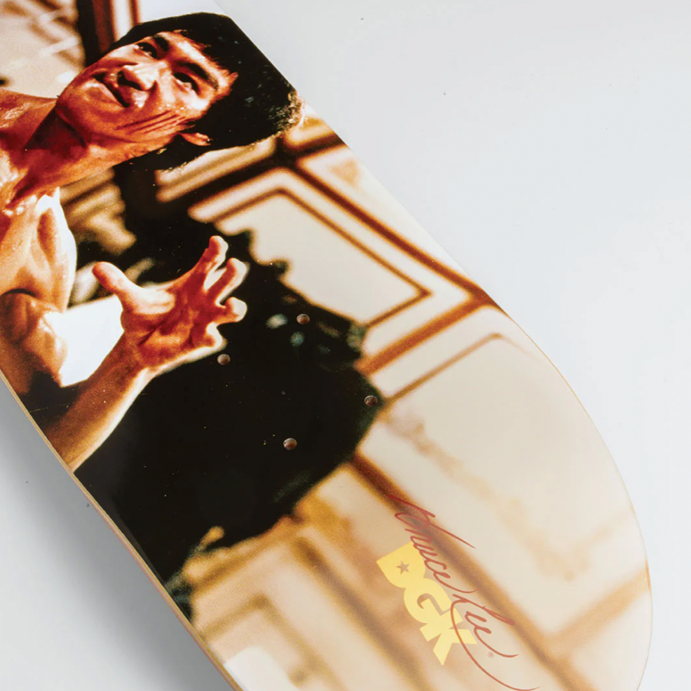 Skateboard deck with a graphic of a person in a martial arts pose on a white background