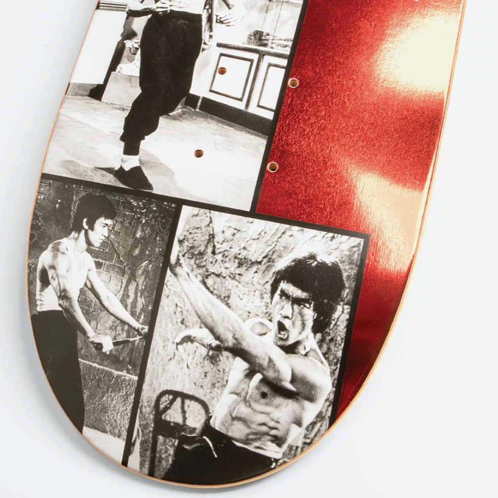 Skateboard deck with black and white images of a person and red text on a white background