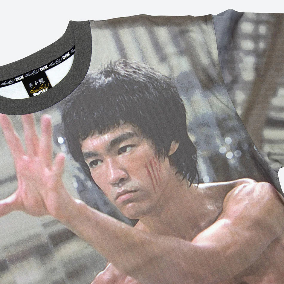 T-shirt with a graphic of a muscular man in a fighting pose, resembling Bruce Lee, on a white background.