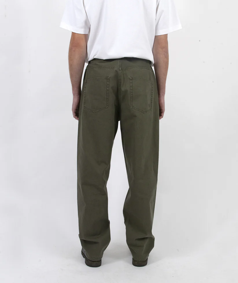 Person wearing olive green pants on a white background