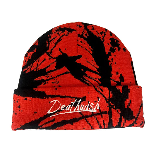 A red and black knit beanie with a distressed splatter pattern and the word 'Deathwish' embroidered in white script on the front cuff, shown against a plain white background.