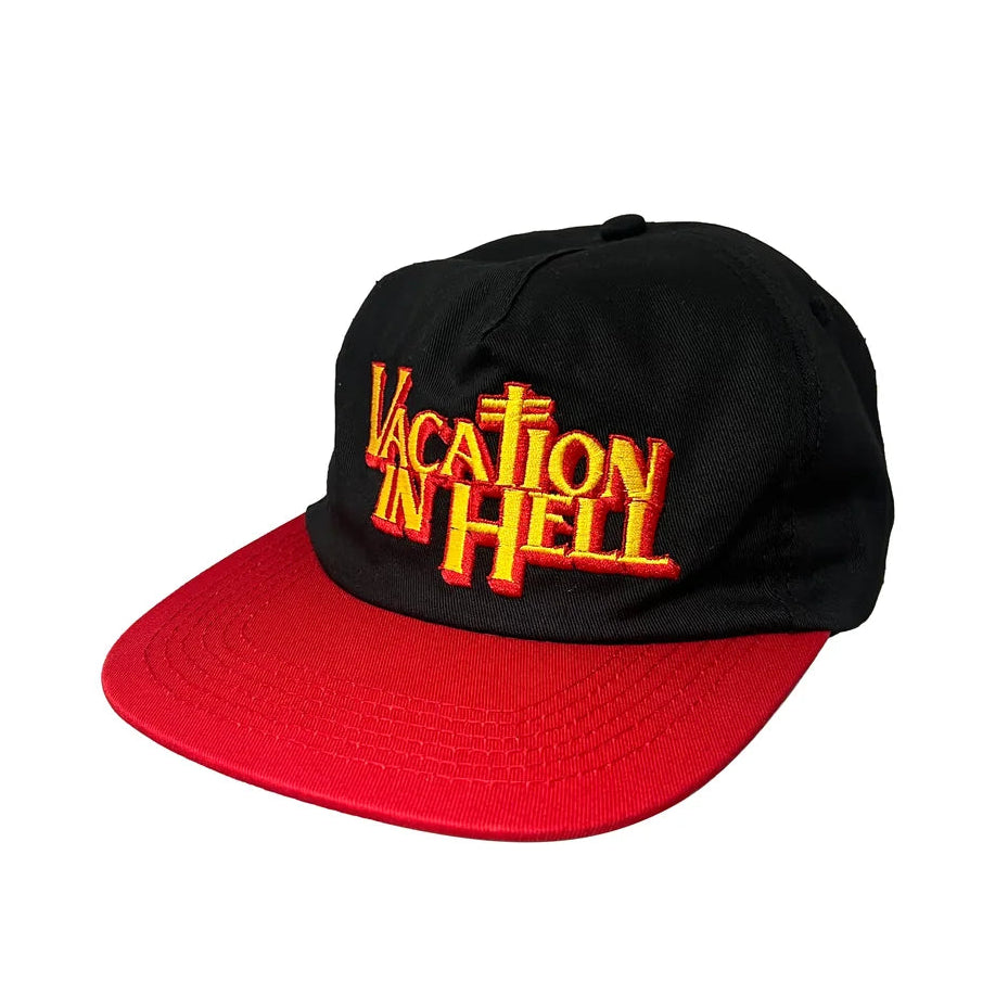 A black baseball cap with a red flat brim, featuring 'VACATION IN HELL' embroidered in red and yellow on the front, set against a plain white background.