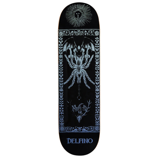 A black skateboard deck featuring a detailed light blue and white graphic design with a large spider, a sun face, and the brand name 'DELFINO' printed in blue at the bottom.