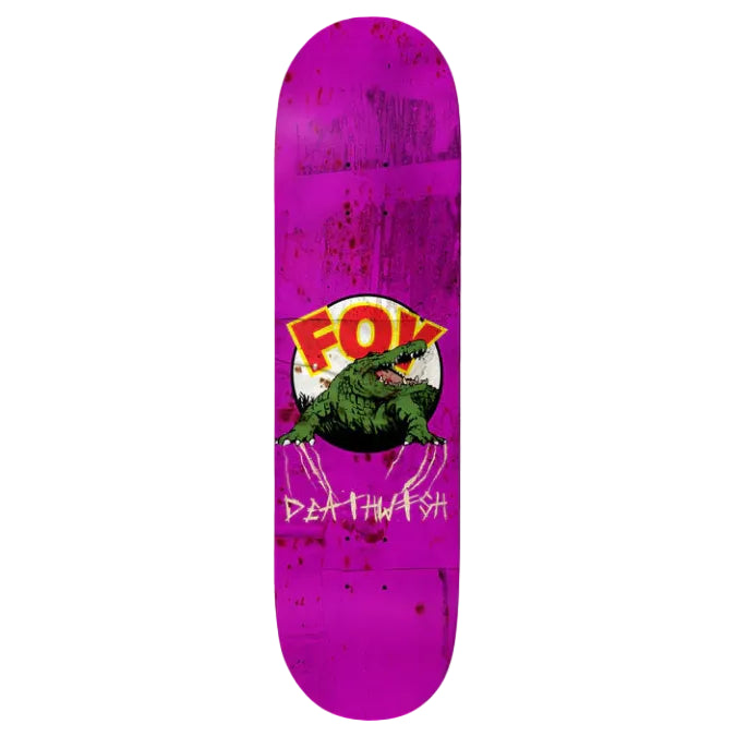 Skateboard deck with a purple splatter design, green dinosaur graphic, and 'FOX' logo on a white background.