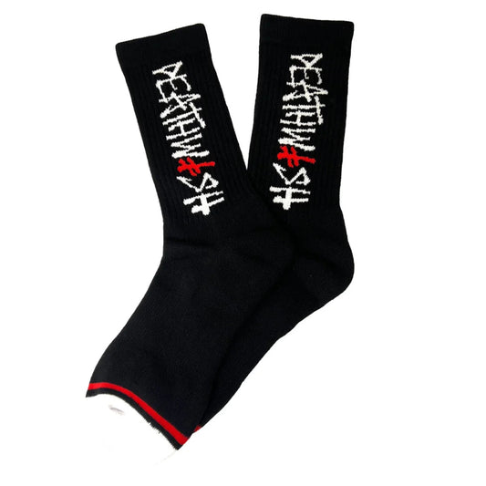 A pair of black crew socks with white and red embroidered Japanese characters on the sides and a red stripe detail at the toe, shown against a plain white background.