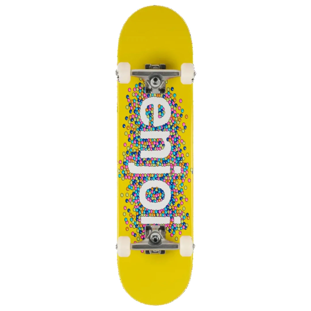 A top-down view of a skateboard deck with a bright yellow background, featuring the word 'enjoy' in large white letters filled with a dense pattern of small multicolored dots. The deck is shown with white wheels and silver trucks against a solid white background.