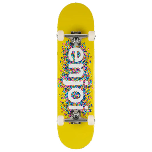 A top-down view of a skateboard deck with a bright yellow background, featuring the word 'enjoy' in large white letters filled with a dense pattern of small multicolored dots. The deck is shown with white wheels and silver trucks against a solid white background.