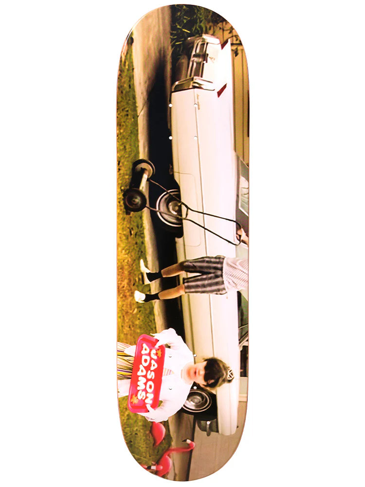 Skateboard deck with a printed design of a person on a motorcycle and a building.