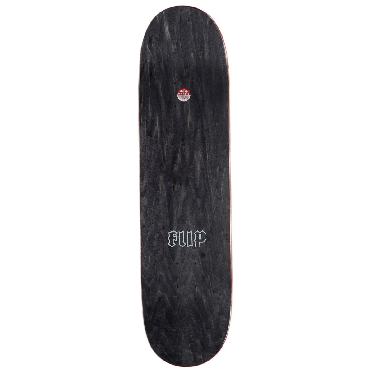 A black skateboard deck with a dark wood grain pattern, featuring a white Gothic-style 'FLIP' logo near the center and a small red and white circular sticker near the tail.