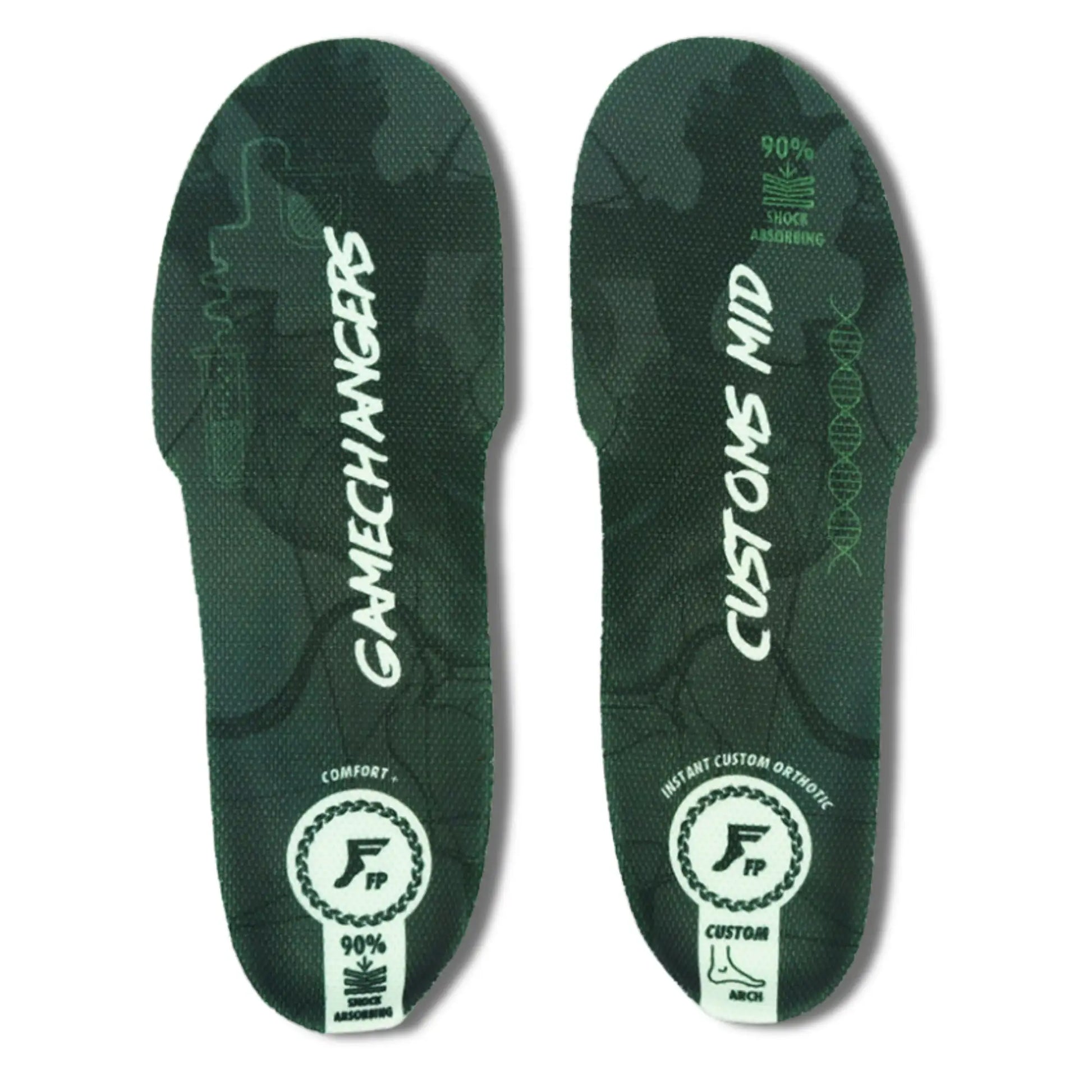 A pair of custom athletic shoe insoles shown from the top on a plain white background. The insoles are dark green with a subtle camouflage pattern, featuring white text that reads 'GAMECHANGERS' on the left insole and 'CUSTOMS MID' on the right insole, along with white circular logo badges and text indicating '90% COMFORT' and 'CUSTOM'.