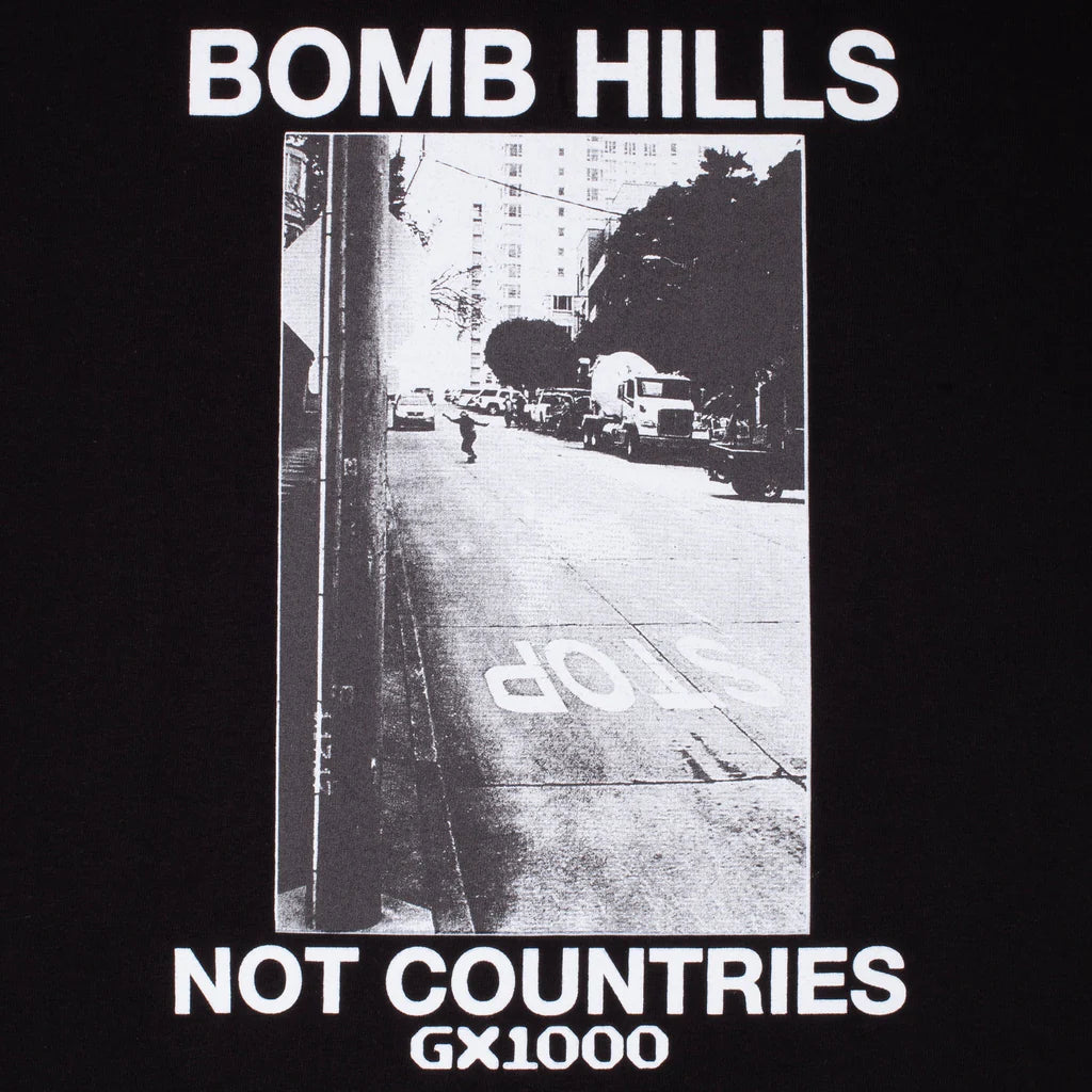 Black t-shirt with a black and white street photo and text 'Bomb Hills Not Countries GX1000' on a dark background