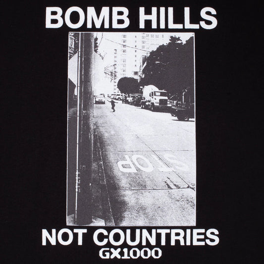 Black t-shirt with a black and white street photo and text 'Bomb Hills Not Countries GX1000' on a dark background