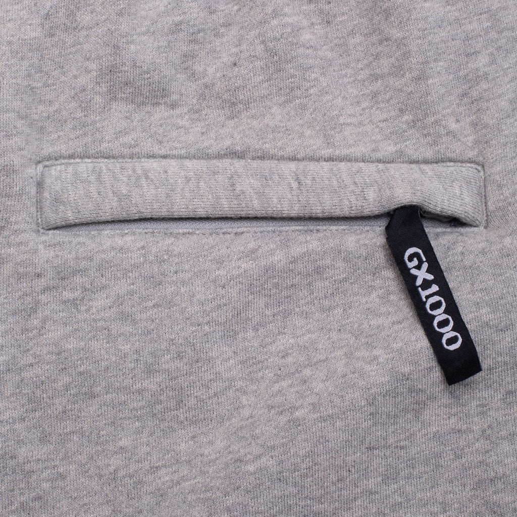 Gray sweatshirt with a black tag displaying 'GX1000' on a gray background