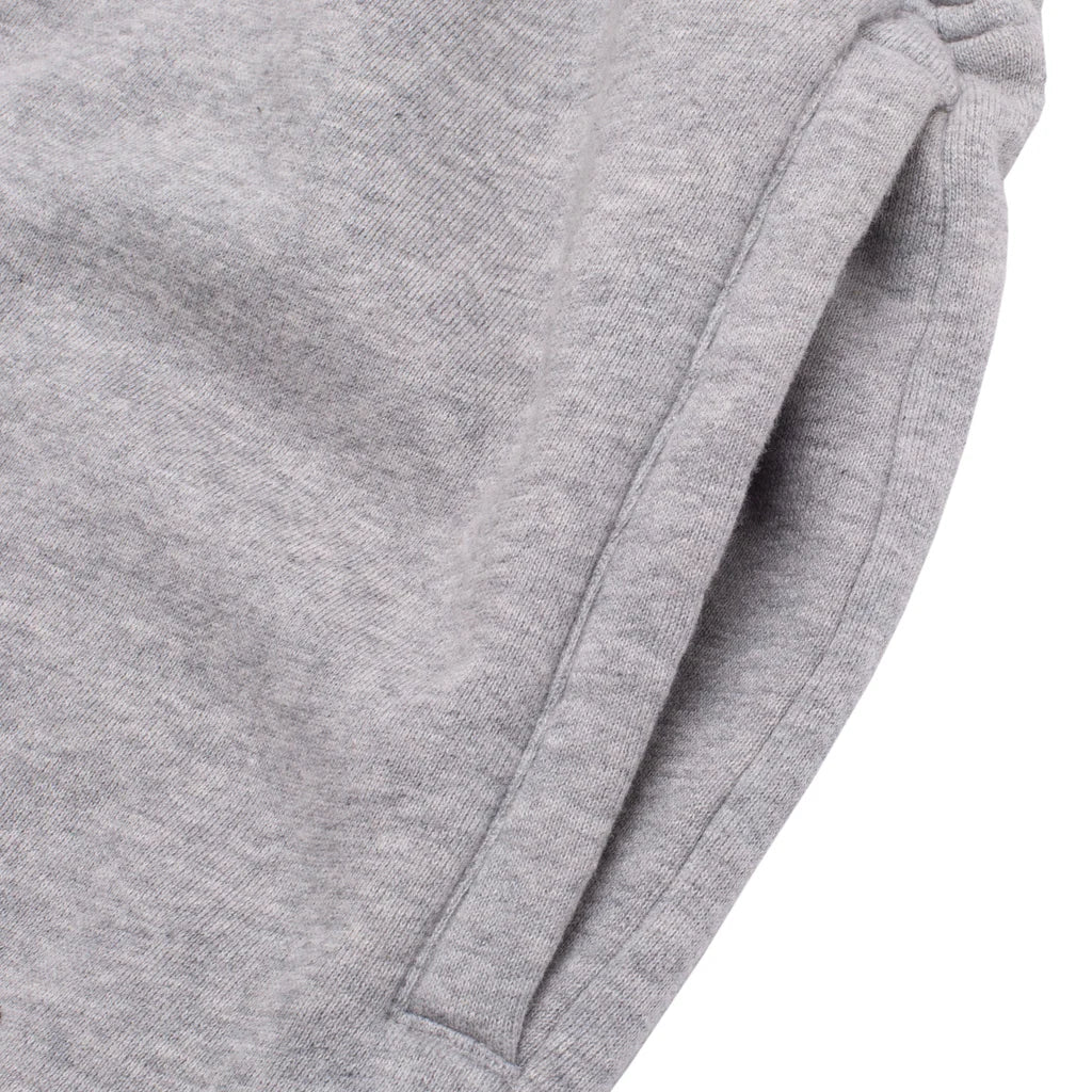 Close-up of gray sweatpants with a white background