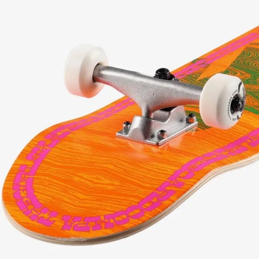 Close-up of a skateboard with an orange deck and pink and green pattern on a white background