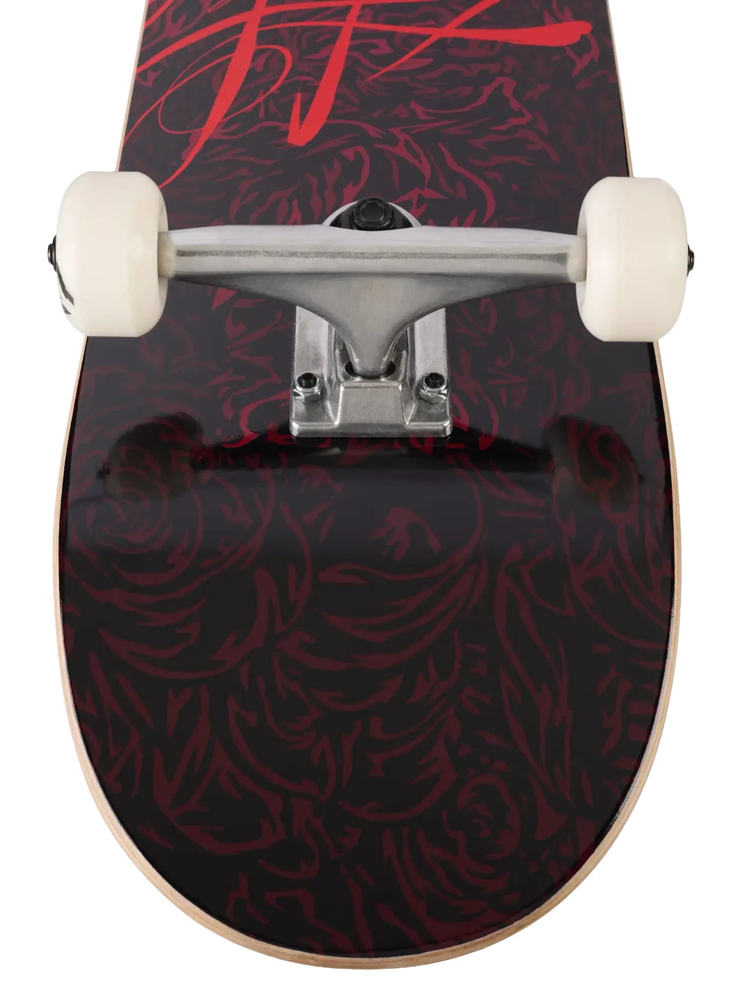 Close-up of a skateboard deck showing a black and dark red floral pattern, silver trucks, and off-white wheels on a white background.