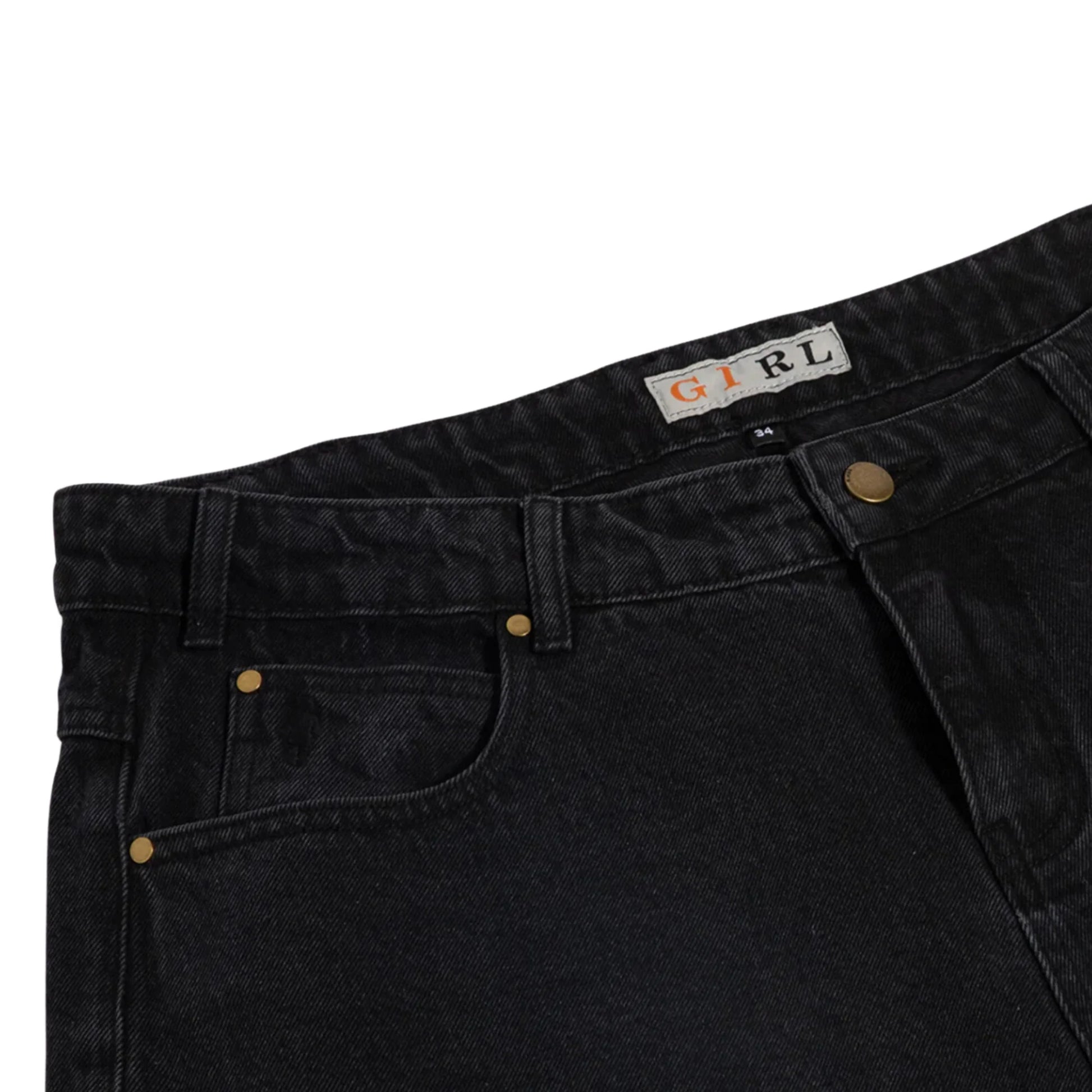 Close-up of black pants with a brand label on a white background