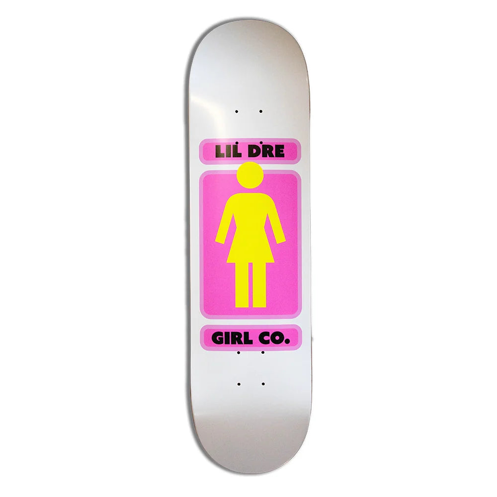 A skateboard deck featuring a white background with a central graphic of a pink square containing a yellow female silhouette, flanked by pink bars with black text reading 'LIL DRE' and 'GIRL CO.'.