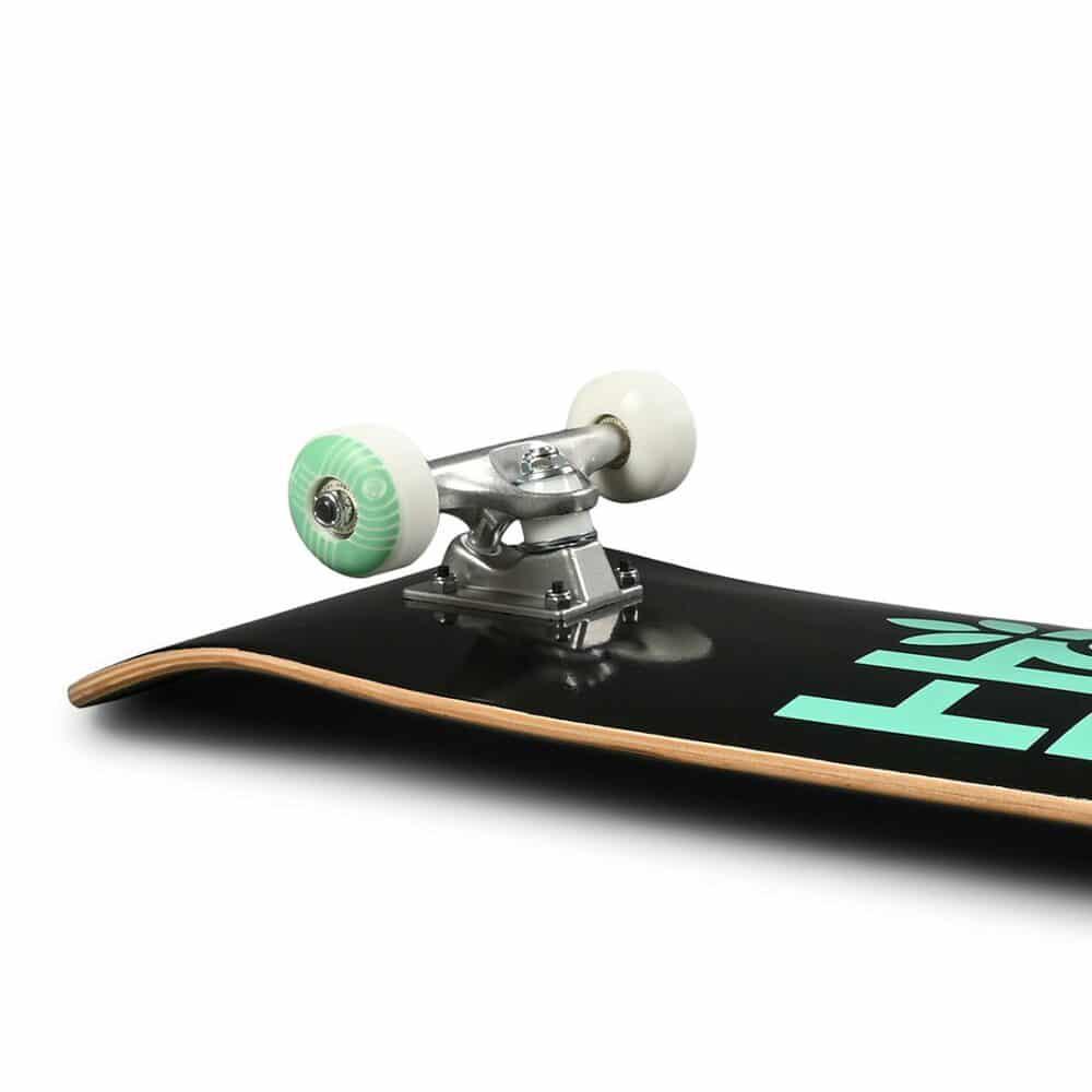 Close-up of a skateboard with visible branding on a white background