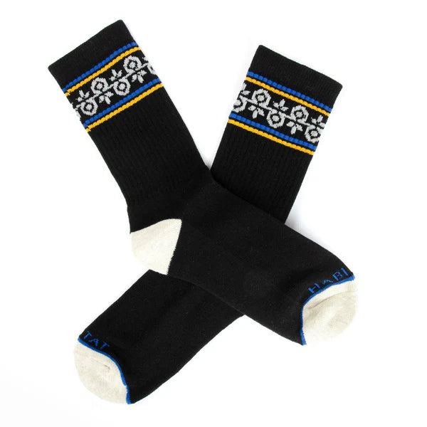 Pair of black socks with decorative patterns on a white background