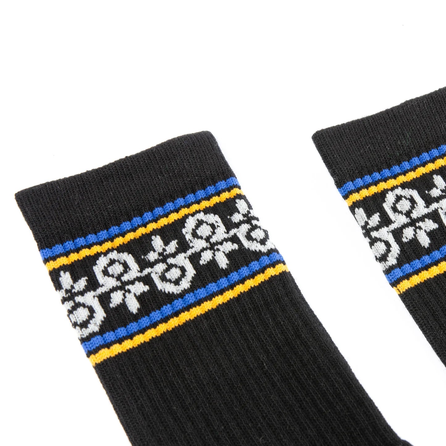Black socks with white pattern and blue and yellow stripes on a white background