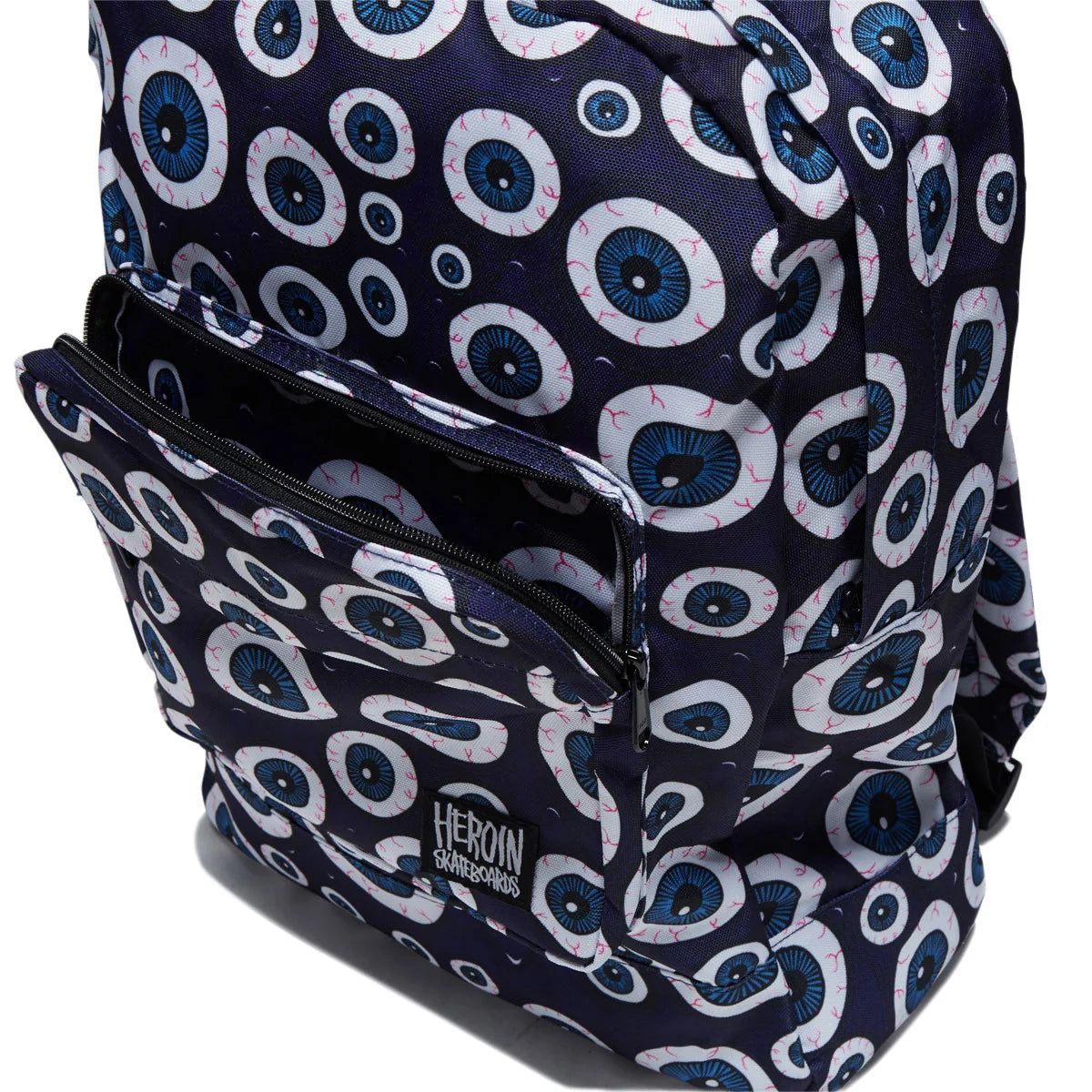 A navy blue backpack with a repeating pattern of white and blue eyeballs, featuring a front zippered pocket and a visible 'HEROIN GAMESCLOUDS' logo patch.