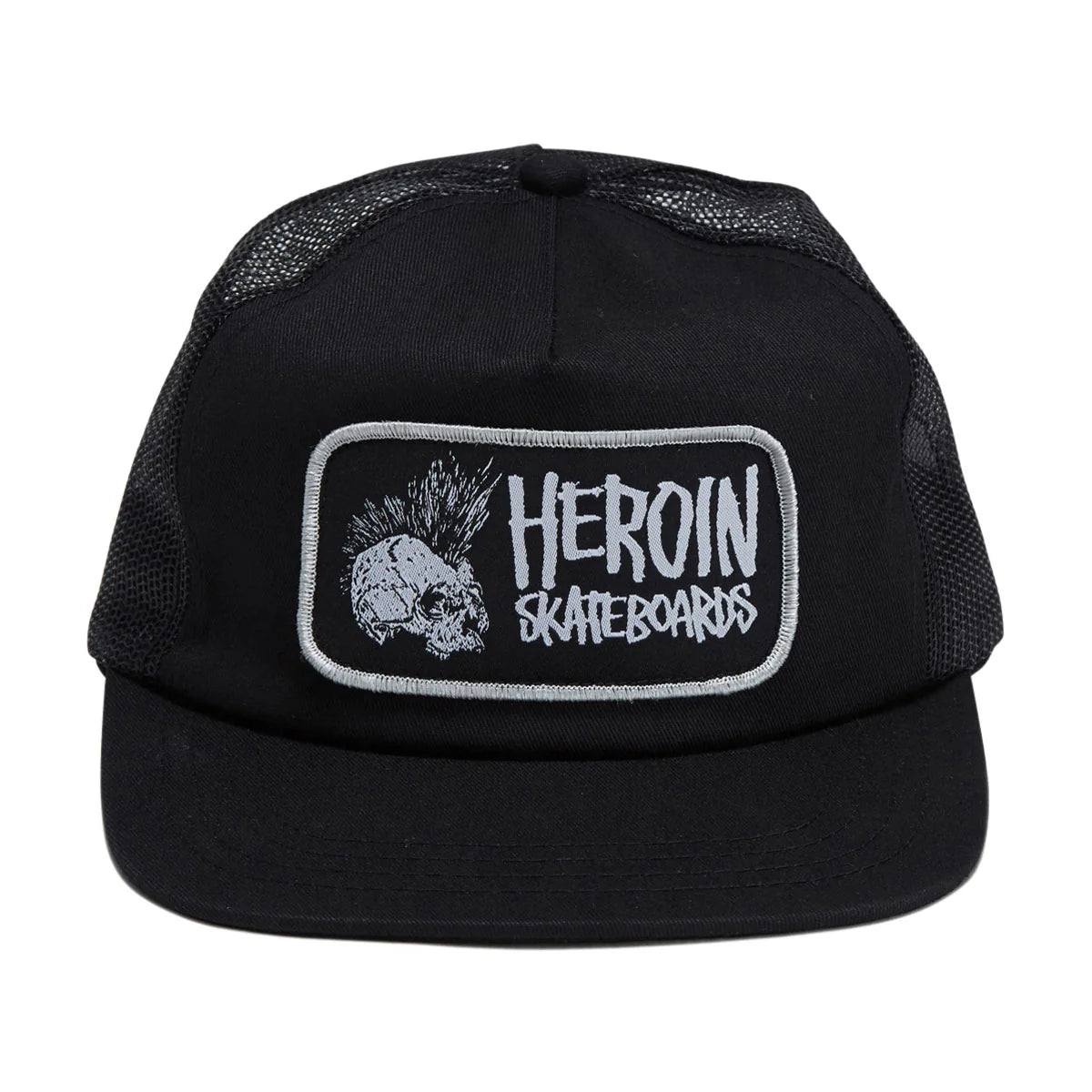 A black trucker hat with a black mesh back and a rectangular embroidered patch on the front. The patch features a white skull with a mohawk, a silver border, and the text 'HEROIN SKATEBOARDS' in white.
