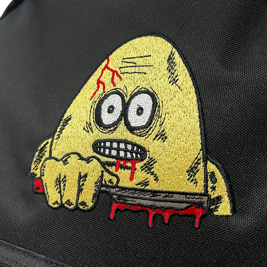 Embroidered patch of a zombie face on a black background