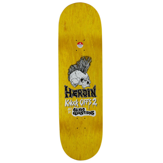 A skateboard deck with a bright yellow wood-grain finish, featuring a graphic of a white skull with a black mohawk and the text 'HERoin Knock Offs 2' and 'craig QUESTIONS'.