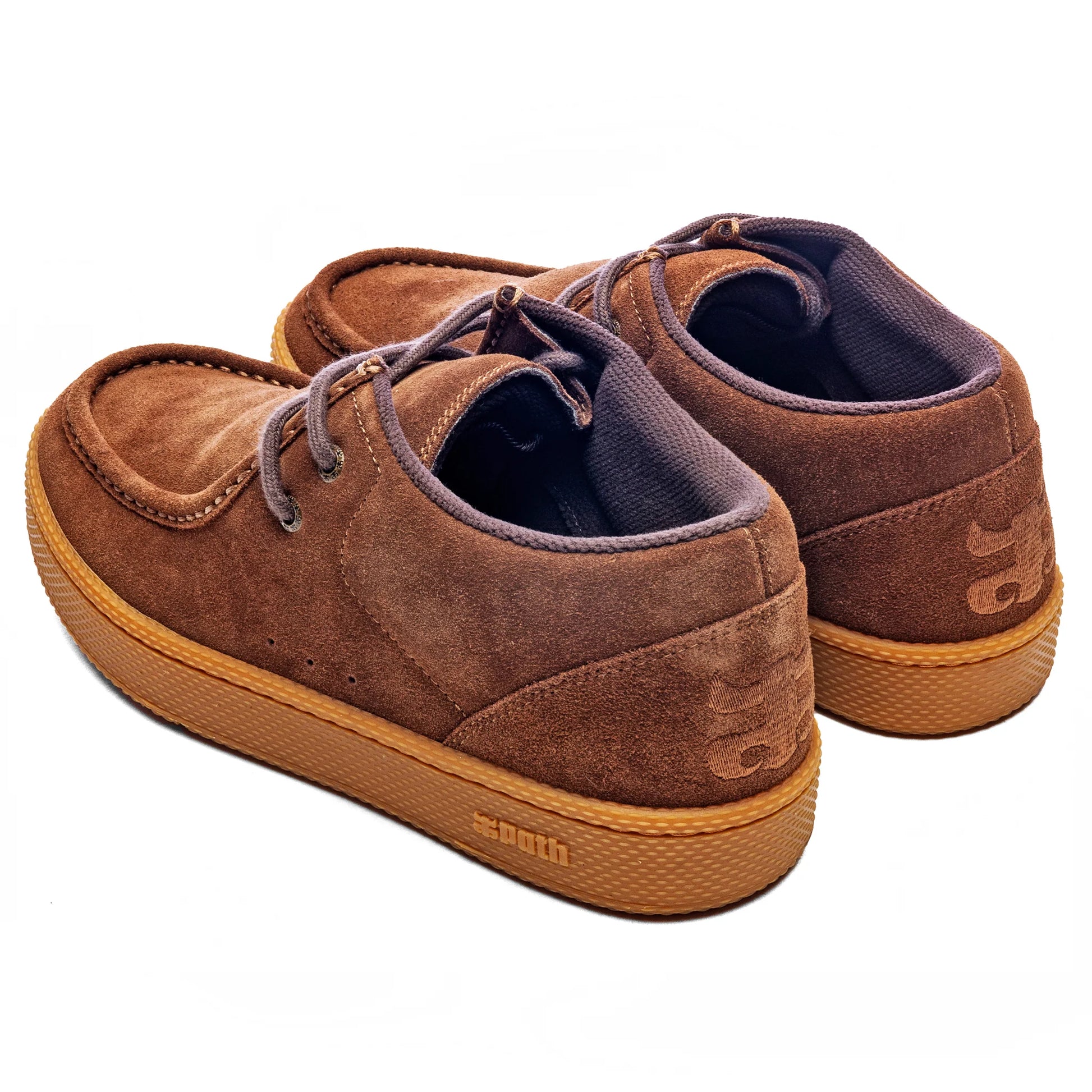 Brown suede shoes with brown soles on a white background