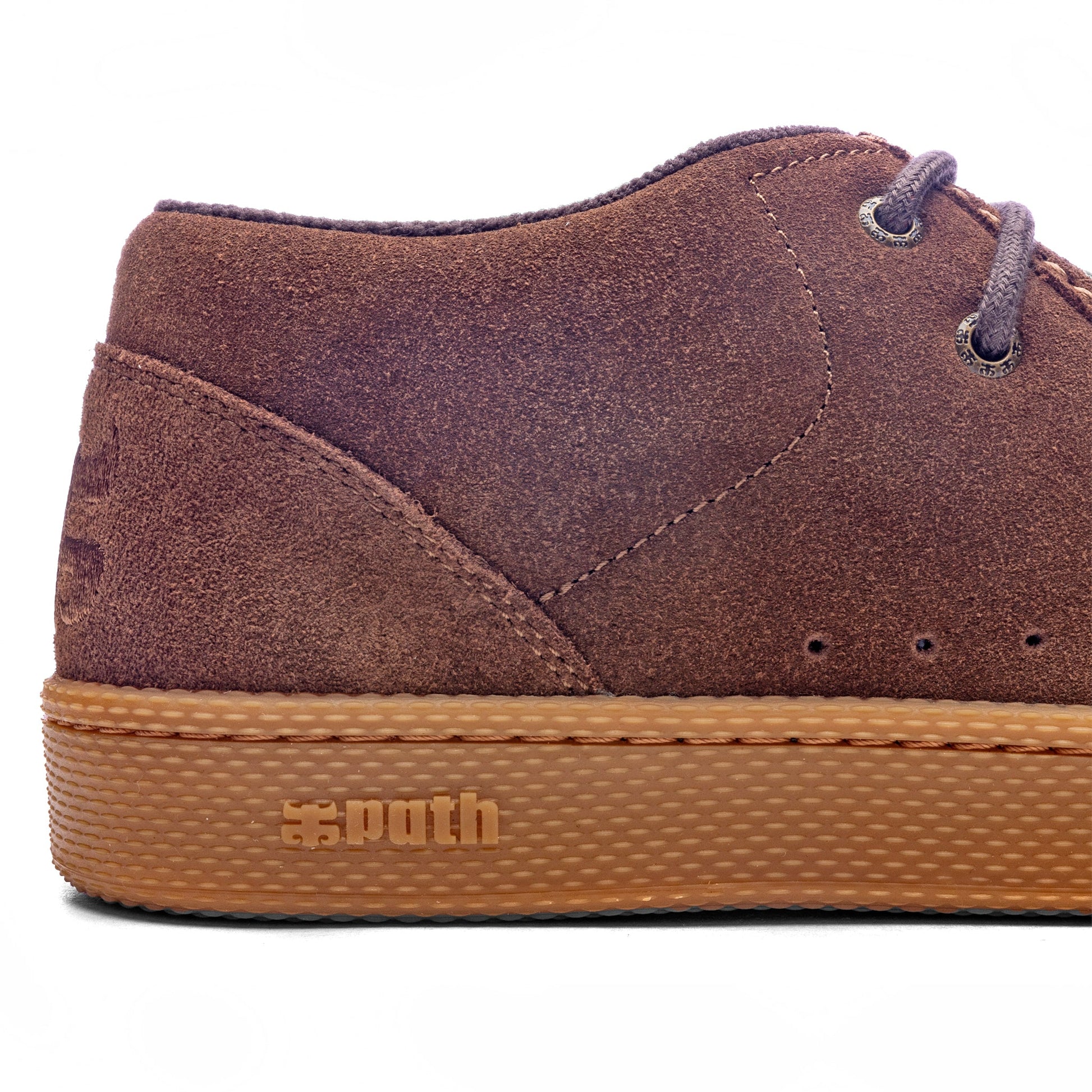 Brown suede shoe with tan sole on a white background
