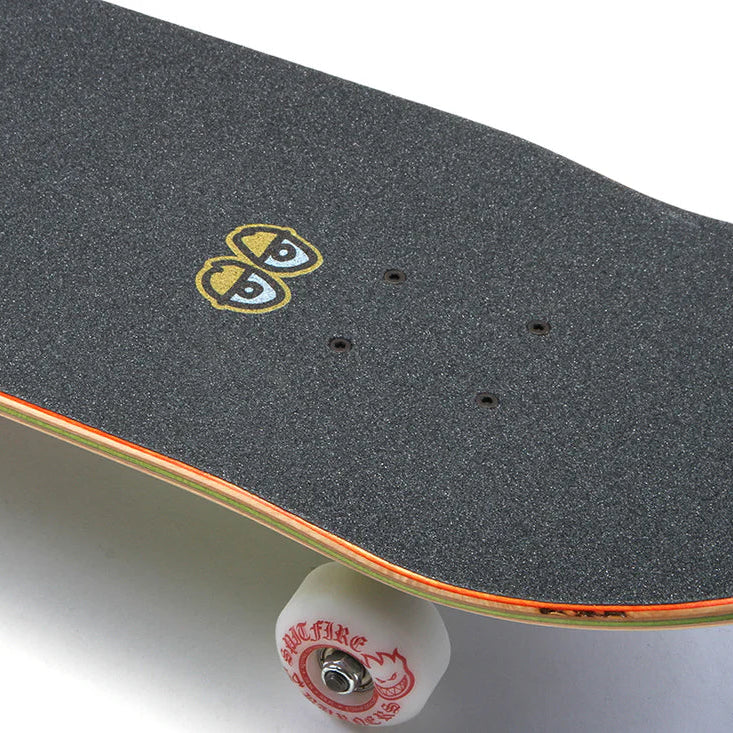 Skateboard with a black deck and red trucks on a white background