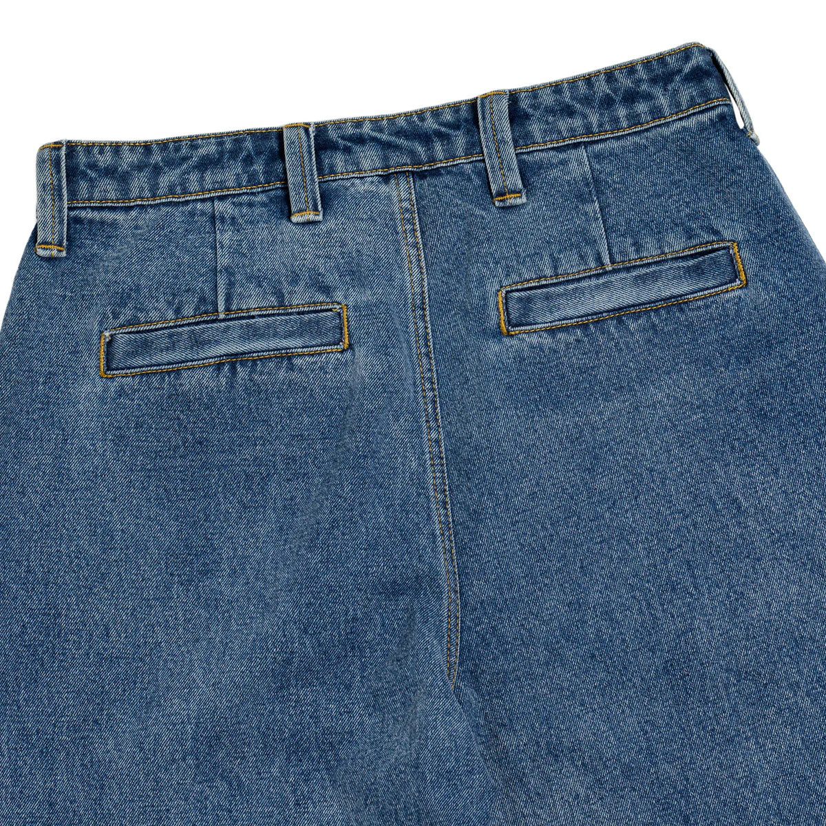Close-up of blue jeans with a focus on the back pocket area.