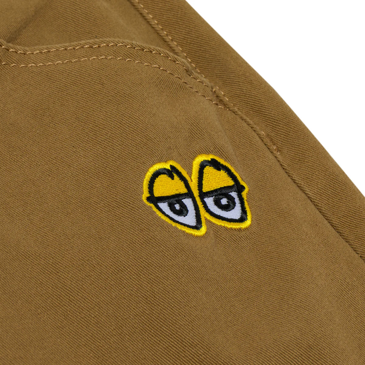 Embroidered eyes patch on a brown fabric background