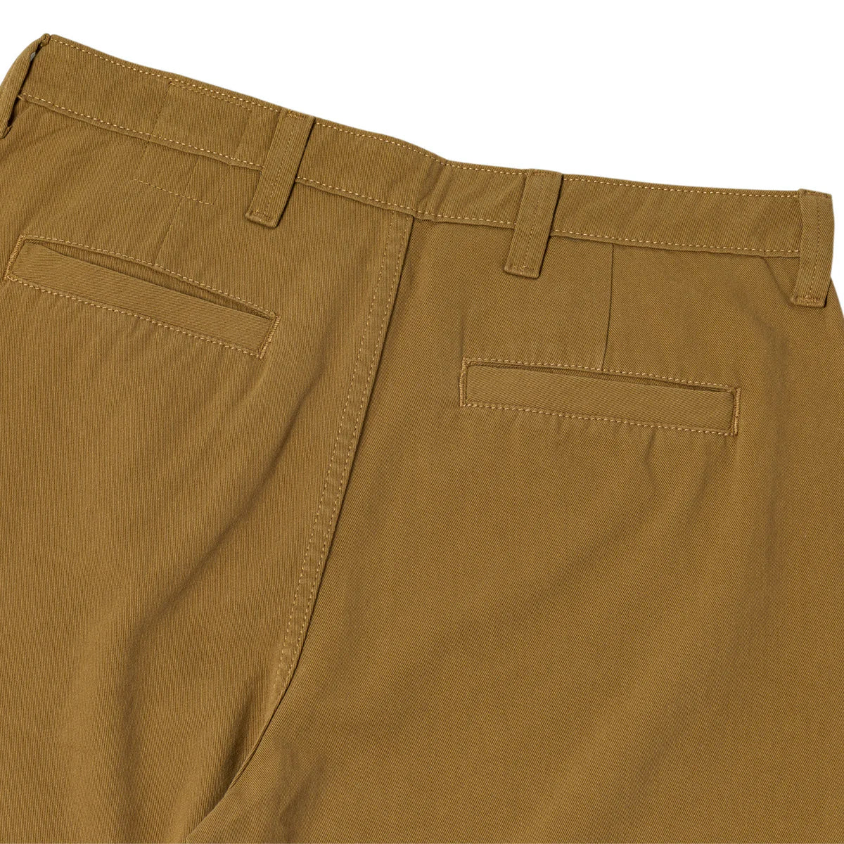 Close-up of brown pants with a white background