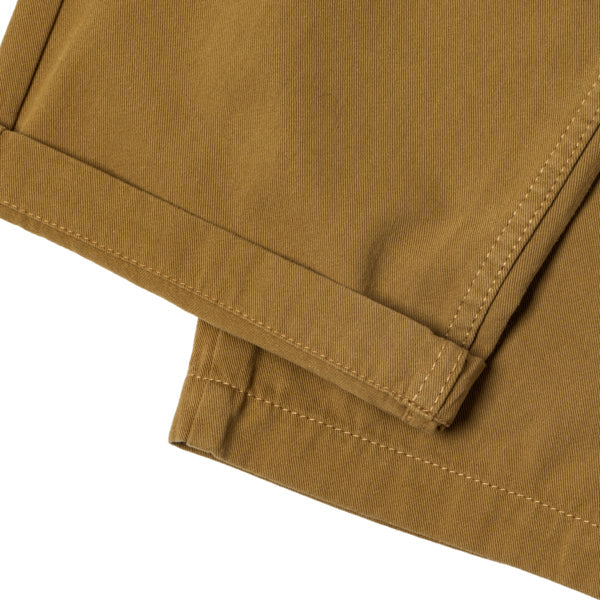 Close-up of a folded brown fabric with visible stitching on a white background